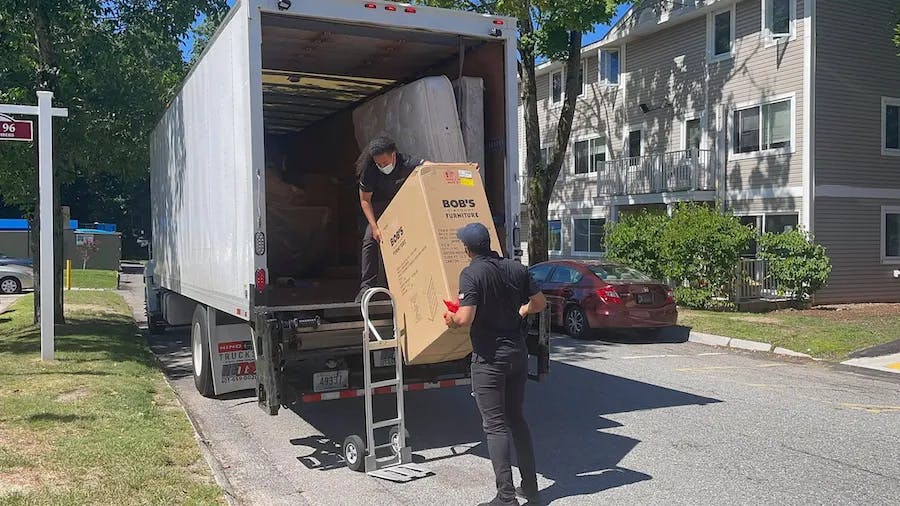 Two people moving boxes