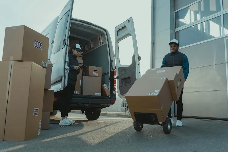 Two people moving boxes
