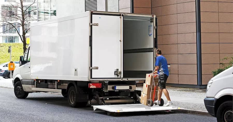 Two people moving boxes
