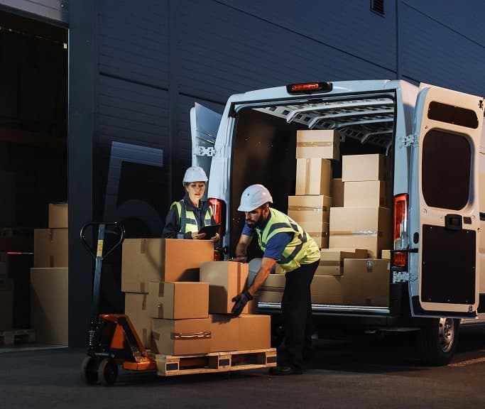 Two people moving boxes